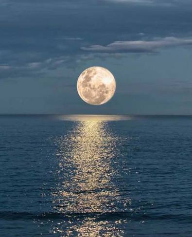 full moon setting over the ocean NTP